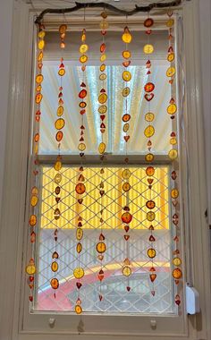 a close up of a window with beads hanging from it