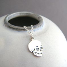 sterling silver skull necklace, 1/2" - Small etched sterling silver skull charm, just over 1/2" (15 mm) down, 3/8" (10 mm) across.  - Necklace is 1.5 mm cable chain, length customizable at the drop down menu. High quality lobster clasp and locking circle jump rings, all sterling silver. - Front is etched and oxidized (blackened) to bring out the details. - Smooth back, with tiny 925 mark.  - Comes wrapped in a cute gift tin, and includes care instructions and a silver polish pad.   Customize cha Minimalist Jewelry For Halloween Gift, Minimalist Halloween Jewelry Gift, Minimalist Halloween Gift Jewelry, Sterling Silver Skull Necklace For Gift, Sterling Silver Charms Necklace For Halloween, Halloween Engraved Sterling Silver Necklaces, Minimalist Skull Jewelry Gift, Nickel-free Sterling Silver Skull Jewelry, Halloween Skull Sterling Silver Jewelry