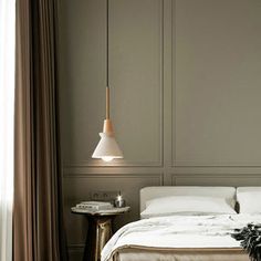 a white bed sitting next to a window in a bedroom