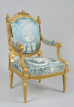 an ornately decorated blue and gold chair