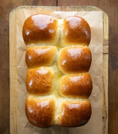 a loaf of bread sitting on top of a wooden cutting board