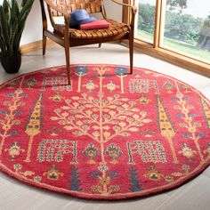 a red rug with an elephant on it in front of a chair and potted plant