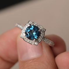 This is a gorgeous handmade creation. Its beauty is its simplicity & Elegance. The 7*7mm round cut London blue topaz is crafted in solid sterling silver and with rhodium plated. All item is sent in a beautiful gift box You can realize more lovely stuff clicking the link https://www.etsy.com/shop/knightjewelry?refshopsection_shophome_leftnav Please leave the correct address and you phone number for delivering successfully. Sapphire-colored Blue Topaz Ring In Round Cut, Sapphire Blue Topaz Ring With Round Cut, Sapphire Colored Round Cut Blue Topaz Ring, Fine Jewelry Blue Topaz Ring With Round Stone, Luxury Sterling Silver Topaz Promise Ring, Sapphire Color Blue Topaz Ring With Round Cut, Blue Topaz Round Band Ring, 14k White Gold Sapphire Topaz Ring With Accent Stones, Blue Topaz Birthstone Ring With Round Band