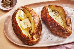 two pieces of bread on a plate with butter and pepper sprinkled on top