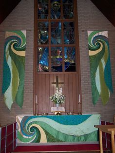 a church with stained glass windows and an ornate bathtub in front of the alter