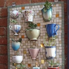 there are many different cups on the wall