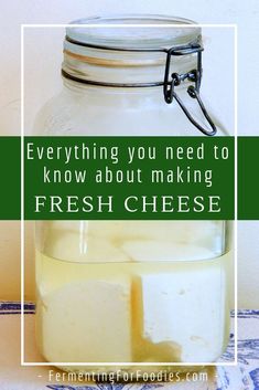 a glass jar filled with cheese sitting on top of a table