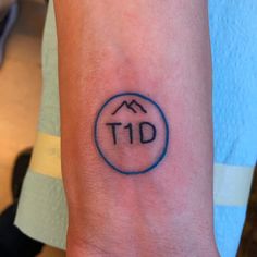 a person with a tattoo on their arm that says tid in the middle of it