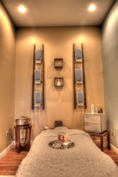 a spa room with white towels and candles