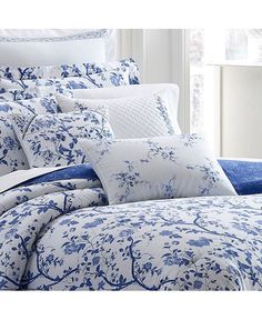 blue and white bedding with flowers on it