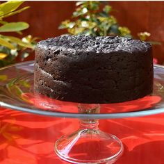 a chocolate cake sitting on top of a glass plate