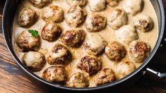 some meatballs and sauce in a pot on a table