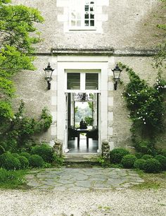 an open door leading into a stone building