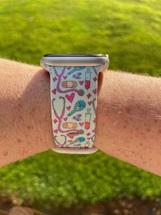 an apple watch on someone's arm in the grass