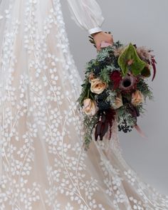 a woman in a wedding dress holding a bouquet