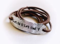 "Wear your daily affirmations and inspirational words on your wrist to remind yourself of what is most important to you every day. :) This leather wrap bracelet features the phrase \"Let Go and Let God\", hand stamped onto hammered aluminum. The soft brown faux suede leather cord is approximately 36\" long and can usually wrap around the wrist 2 times. The. Just tie a loose knot or two in the back to secure and you are good to go! You can have this bracelet with or without the tiny cross at the Inspirational Handmade Name Bracelet For Everyday, Everyday Inspirational Handmade Name Bracelet, Inspirational Handmade Name Bracelet, Inspirational Handmade Bracelets For Everyday, Inspirational Handmade Bracelet For Everyday, Inspirational Engraved Bracelets For Everyday, Everyday Inspirational Engraved Bracelets, Inspirational Engraved Everyday Bracelets, Inspirational Engraved Adjustable Name Bracelet