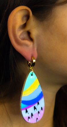 These handpainted earrings are the perfect statement piece - an artful combination of brush strokes that make a statement. Put 'em on, and you'll be the talk of the town! Seriously though, these earrings will bring out your inner artist with a look that's uniquely yours. These multi-color beauties shimmer and shine with a resin finish and iridescent details. Plus, the gold accents and gold finished hardware add a luxe touch. Colors will vary on different screens. Most appear brighter in person. Colorful Hand-painted Drop Earrings, Colorful Hand Painted Drop Earrings, Artsy Hand Painted Colorful Earrings, Hand Painted Yellow Artsy Earrings, Yellow Hand Painted Artsy Earrings, Artistic Hand Painted Drop Earrings, Hand Painted Earrings, Painted Earrings, Talk Of The Town