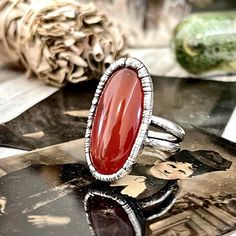 Big Natural Carnelian Statement Ring in Fine Silver -A beautiful piece of Carnelian Set in silver and given a vintage patina. - Ring Length Approximately 1.26" Choose ring size at checkout. You will receive one ring in your choice of size. -Each piece is made by me in my home studio. All items come ready for gift giving in a recycled kraft paper jewelry box. -Our silver jewelry is created by a unique precess. First forming a thick layer of copper to create an organic look and texture and then ea Pisces Jewelry, Displaying Crystals, Carnelian Crystal, Vintage Silver Rings, Carnelian Ring, Paper Jewelry, Large Crystals, One Ring, Brass Jewelry