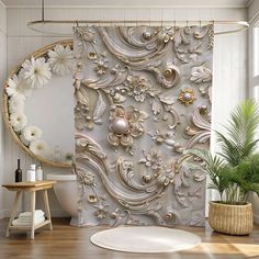 a bathroom with a flowery shower curtain in the middle and a round mirror on the wall