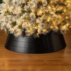 a white christmas tree in a black pot