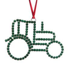 a green ornament shaped like a tractor