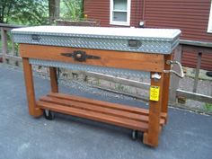 a wooden bench with a metal box on it