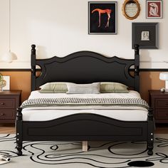 a bedroom with a bed, nightstands and pictures on the wall above it in black