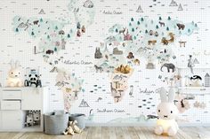 a child's room with a map wallpaper and toy animals on the floor