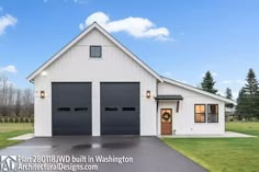 a white house with two black garage doors