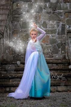 This couture gown is befitting of the Ice Queen herself with its amazing iridescent ice blue fabric, gorgeous crystal "ice" detailing at the bodice and flowy white cape. It's extremely easy to wear with a lightweight feel. This dress makes the perfect sister set with the Anna Coronation dress. Measurements: Across the chest: 13 inches Across the waist: 11 inches Shoulder to hem: 55 inches Fits like a 10/12/14 White Ethereal Prom Dress, Costume Dress With Fitted Bodice In Tulle, Tulle Dress With Fitted Bodice For Costume, Blue Princess Gown For Costume Party, White Fitted Fairy Dress, Fairytale-style Fitted Dress For Pageant, Fairytale Fitted Dress For Pageant, Fairytale Fitted Pageant Dress, Fitted White Fairytale Fairy Dress