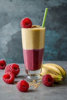 a smoothie with raspberries on the side