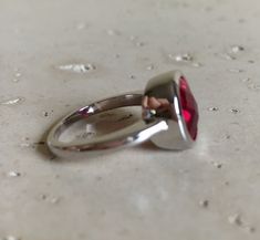 "A Classic oval shaped Faceted Lab Created Ruby Sterling Silver Ring featuring a comfort fit band with a bezel around the stone. This makes a great birthstone ring for those July Birthdays! Wrapped in a box ready for gift giving.(r-537) RING INFO ---------------- STERLING SILVER Stone with Bezel measure 11.5mm x 10mm July BIRTHSTONE *Follow us @belesasjewelry on Instagram for promotions/giveaways *LIKE* us on Facebook http://www.facebook.com/Belesas *If you like the ring, please click on the \"P Adjustable Red Oval Ruby Ring, Adjustable Oval Red Ruby Ring, Red Round Ring For Everyday, Everyday Red Round Ring, Modern Oval Ruby Ring With Bezel Setting, Red Oval Stackable Promise Rings, Red Bezel-set Round Band Rings, Red Ruby Ring With Bezel Setting, Red Oval Ring With Bezel Setting