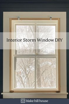 a window with the words interior storm window diy on it and trees in the background