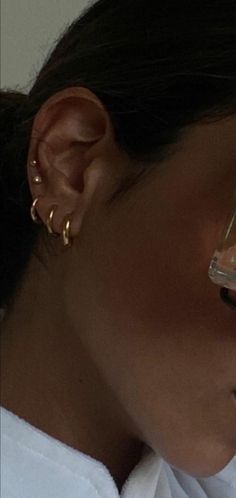 a close up of a person wearing ear clips