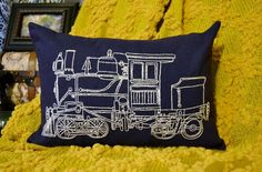 a pillow with a train drawn on it