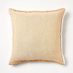 a beige pillow on a white background