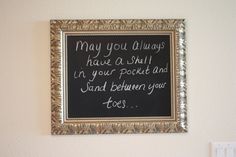 a chalkboard with some writing on it in a gold frame hanging on the wall