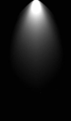 a black and white photo of a light in the dark