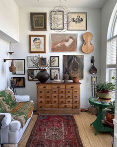 a living room filled with furniture and pictures on the wall