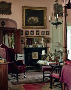 a living room filled with furniture and a painting on the wall