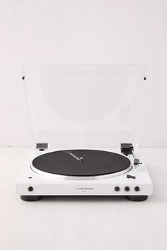 a white turntable sitting on top of a table