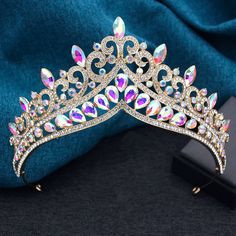 Enhance your party look with the Princess Royal Queen Tiara Crowns. The high point design and colorful crystal details add a touch of sophistication to any outfit. Made with a sturdy metal frame and featuring veil loop ends, these tiaras are a must-have for your next regal event. material: metal, crystal gender: women type: tiara crown colors: as shown style: pageant, party height:: around 7 cm diameter:: around 15 cm Glamorous Crown Headpiece For Party, Princess Style Headpiece With Teardrop Crown For Parties, Princess Style Party Headband, Teardrop Crown Headpiece With Rhinestones For Parties, Crystal Crown Headpiece For Party, Silver Structured Crown For Party, Teardrop Rhinestone Crown For Party, Teardrop Crown With Rhinestones For Party, Teardrop Rhinestone Party Crown