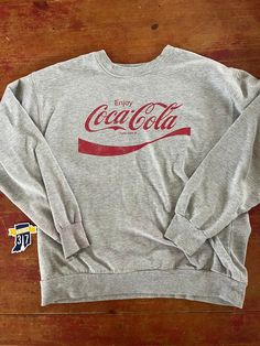 Vintage Coca Cola Crewneck Sweatshirt  Size Large  See pics for measurements  Classic Gray with classic red logo of this iconic brand  Simple and understated  Fine condition  Quick shipping.   We ship same or next day with USPS mail  We are a small family business and we appreciate your purchase, Godspeed ! Gray Crewneck, Vintage Coca Cola, Classic Gray, Grey Crewneck, Coca Cola Vintage, Red Logo, Small Family, Family Business, Coca Cola