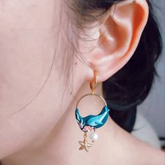 a close up of a person wearing some kind of earring with starfish on it