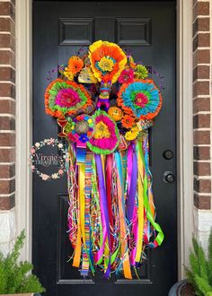 a door decorated with colorful flowers and streamers