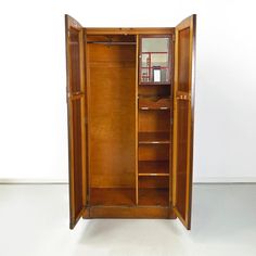 an open wooden cabinet with shelves and drawers