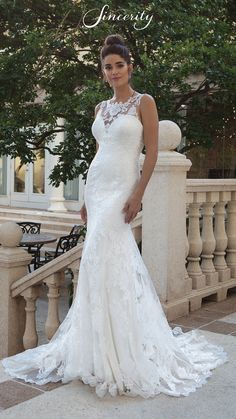 a woman in a white wedding dress standing on a balcony with her hand on her hip