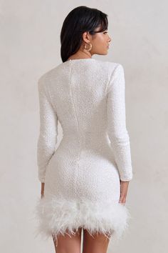 With so many sparkling sequin embellishments, our Claudia is truly a party season must-have. The little white dress features a high neckline and long sleeves with padded shoulders to exaggerate your curves. Making this mini dress all the more memorable are the feathers tickling its short hemline. Features- Premium sequin fabric- High neckline- Long sleeves- Feathered hemline- Invisible zip closure- Mini length Sizing & FitModel is 5'6" and wears UK size 8 / US size 4 Product InformationDesigned exclusively at Club L LondonPartially lined with moderate stretchPremium sequin fabric in White (100% PET, 95% Polyester, 5% Elastane)Trim: 100% real feathers85cm total lengthSKU: CL128035005 Product CareTo prolong the life of your feathers, please dry clean this product only.Please hang this style Winter Mini Dresses, Little White Dress, Black Dress Prom, Sequin Decor, Black Tie Gala, Fall Winter Dresses, Dress With Long Sleeves, Invisible Zip, Little White Dresses