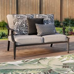 a couch sitting on top of a wooden deck