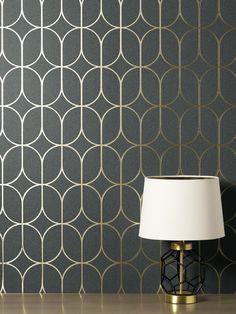 Mid century modern elegance gets a chic update with this trellis wallpaper! A chic and simplified star form sits inside elongated ovals, the shapes detailed in flashy metallic gold against a distressed charcoal backdrop. Raye is an unpasted, paper wallpaper. Fine Decor Raye Charcoal Rosco Trellis Wallpaper in Gray | FD42804 Modern Trellis Design, Foil Wallpaper, Room Wallpaper Designs, Modern Trellis, Charcoal Wallpaper, Trellis Wallpaper, Feature Wallpaper, Trellis Design, How To Hang